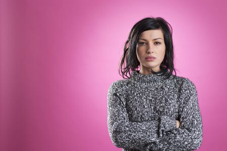 Portrait of upset girl with messy look and crossed arms.