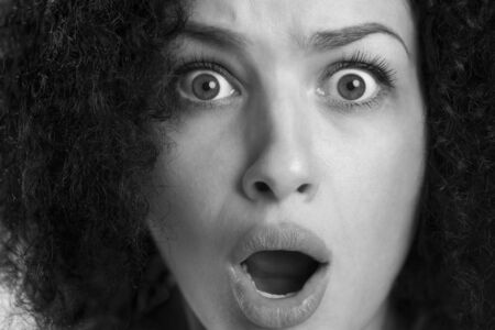 Macro portrait of a scared girl in black and white.
