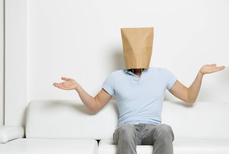 Confused man with paper bag covering his head.の写真素材