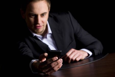 Businessman checking text messages on phone.
