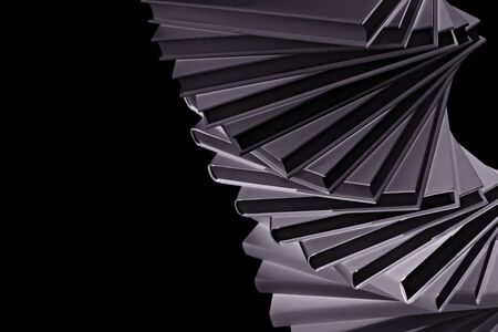 Black & White art conversion of spiral stack of real books, tilted.の写真素材