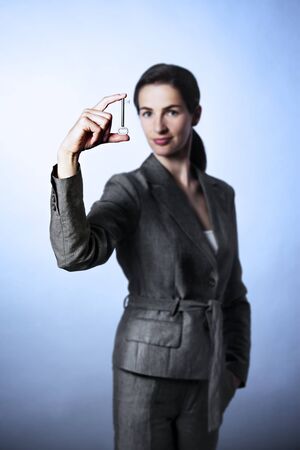 Key to success, woman holding key between fingersの写真素材