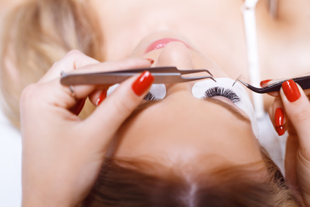 Eyelash Extension Procedure. Woman Eye with Long Eyelashes. Lashes. Close up, selected focus.の写真素材