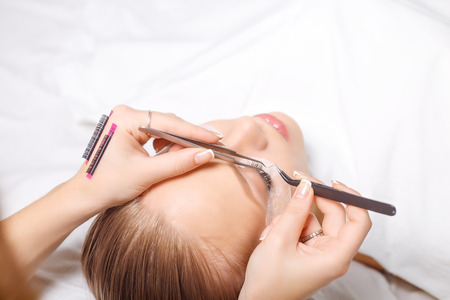 Eyelash Extension Procedure. Woman Eye with Long Eyelashes. Lashes. Close up, selected focus.