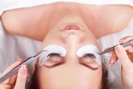 Eyelash Extension Procedure. Woman Eye with Long Eyelashes. Lashes. Close up, macro, selective focus