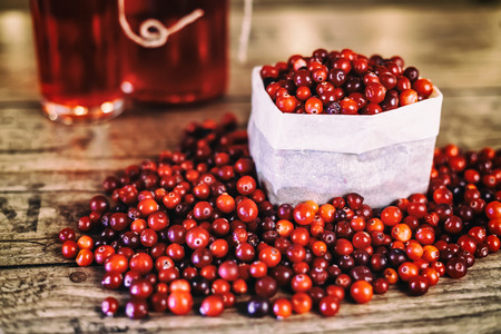Heap of fresh Cranberries on vintage wooden backgroundの写真素材