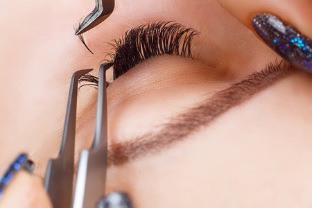 Eyelash Extension Procedure. Woman Eye with Long Eyelashes. Lashes, close up, macro, selective...