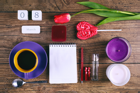 Set of woman accessories Pink Tulip Flower, lollipop, the date block calendar and two cendels on rustic table for March 8, International Womens Day, Birthday, Valentines Day or Mothers day - Top Viewの写真素材