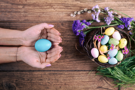 Girl holding easter eggs in her hands. Toned picture. Top view. Selective focus.の写真素材