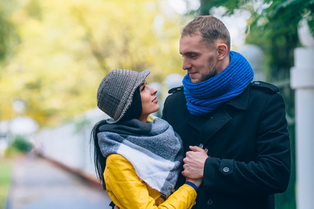Young people in autumn park. Yellow Trees and Leaves. Happy young family concept.の写真素材