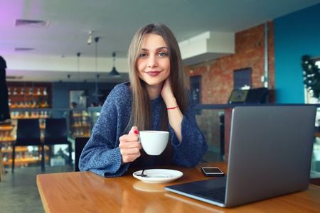 beautiful young girl resting in a cafe. Toned. Selective focus.