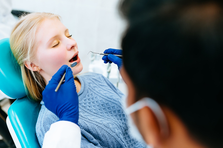 young confident asian male dentist Medical treatment to a female patient at the clinic. Dental clinic concept.の写真素材