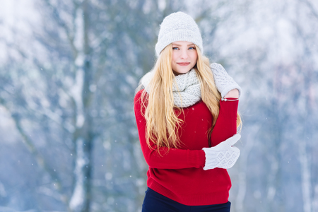 Winter young teen girl portrait. Beauty Joyful Model Girl laughing and having fun in winter park. Beautiful young woman outdoors. Enjoying nature, wintertimeの写真素材