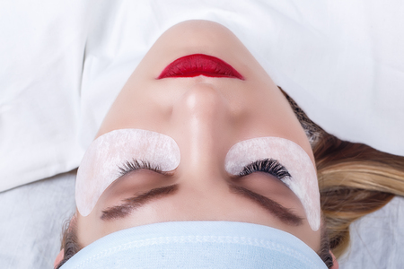 Eyelash Extension Procedure. Woman Eye with Long Eyelashes. Lashes, close up, selected focus.の写真素材