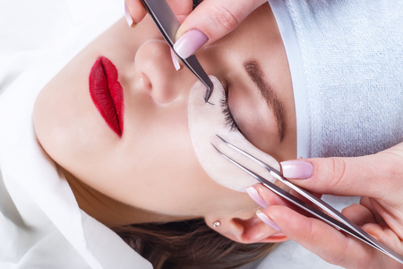 Eyelash Extension Procedure. Woman Eye with Long Eyelashes. Lashes, close up, selected focus.