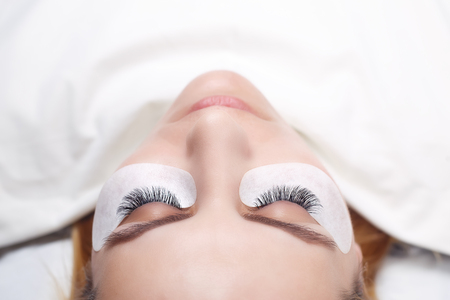 Eyelash Extension Procedure. Woman Eye with Long Eyelashes. Lashes, close up, selected focus.の写真素材