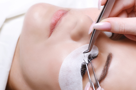 Eyelash Extension Procedure. Woman Eye with Long Eyelashes. Lashes, close up, selected focus.