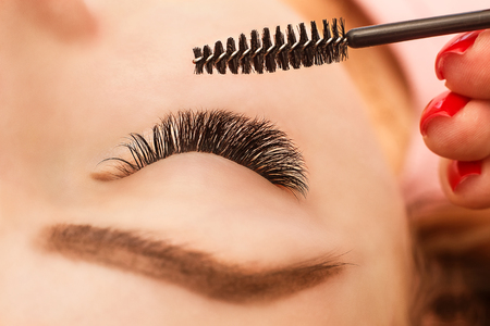 Eyelash Extension Procedure. Woman Eye with Long Eyelashes. Close up, selective focus.の写真素材