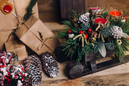 Christmas Gifts with Boxes on Wooden Background. Vintage Style. Closeup, selective focus. Toy, bear, sled. Christmas concept.の写真素材