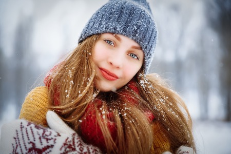 Winter young woman portrait. Beauty Joyful Model Girl laughing and having fun in winter park. Beautiful young female outdoors, Enjoying nature, wintertimeの写真素材