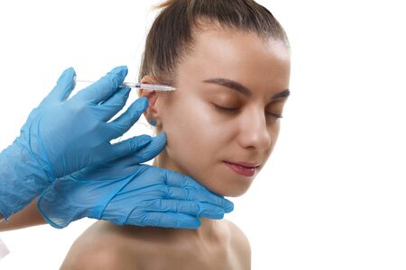 Facial Beauty Injections. Portrait Beautiful Young Woman Receiving Hyaluronic Acid Injection. Closeup Of Hands In Gloves Holding Syringe Near Attractive Female Face.の写真素材