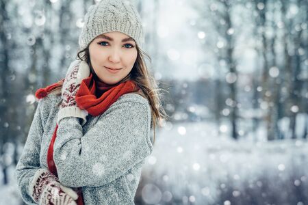 Winter young woman portrait. Beauty Joyful Model Girl laughing and having fun in winter park. Beautiful young female outdoors, Enjoying nature, wintertimeの写真素材