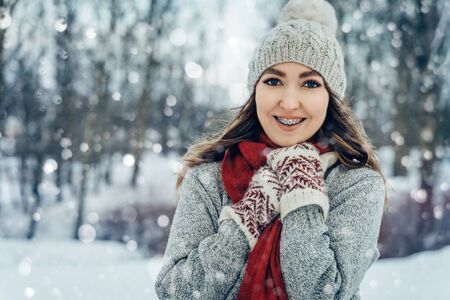 Winter young woman portrait. Beauty Joyful Model Girl laughing and having fun in winter park. Beautiful young female outdoors, Enjoying nature, wintertimeの写真素材