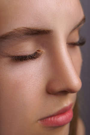 Eyelash Extension Procedure. Woman Eye with Long Eyelashes. Close up, selective focus.の写真素材