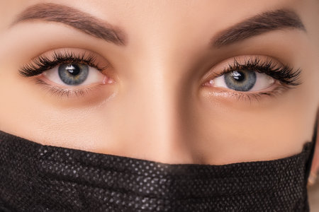 Eyelash Extension Procedure. Beautiful Woman with Extreme Long False Eyelashes. Makeup, Cosmetics....