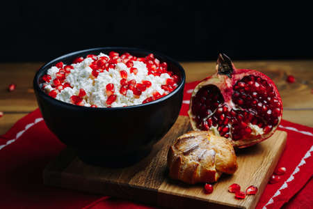 Cottage Cheese In Bowl. Homemade Curd Cheese Served With pomegranate seeds in a bowl. Healthy breakfast concept.の写真素材
