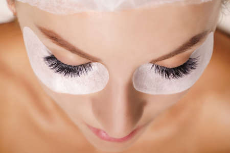 Eyelash Extension Procedure. Woman Eye with Long Eyelashes. Close up, selective focus.の写真素材