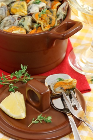 Tasty mussels in a brown ceramic saucepanの写真素材