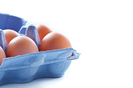 Brown eggs in blue opened package.