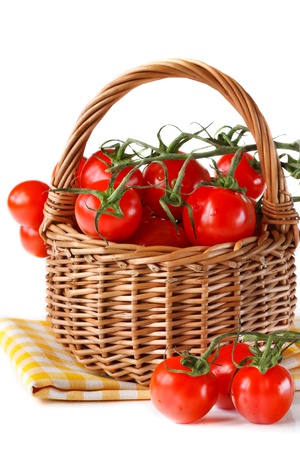 Fresh garden tomatoes in a wicker basket.の写真素材