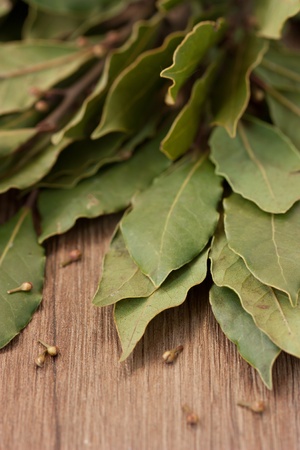 Bay laurel leaves on a wooden board.の写真素材