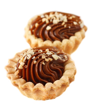 Delicious caramel cakes with nuts over white.の写真素材