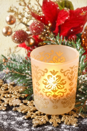 Christmas candle on a golden snowflake.の写真素材