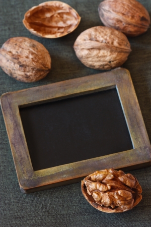 Composition with walnuts and empty vintage chalk blackboard tag.の写真素材
