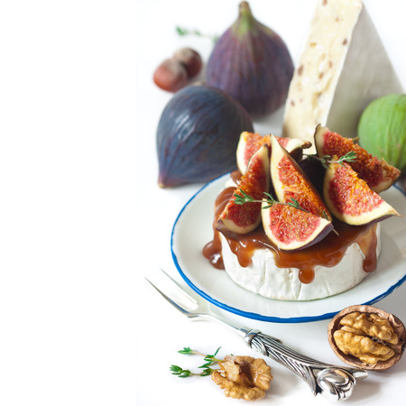 Delicious camembert with dark honey and figs.の写真素材
