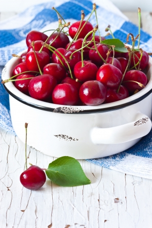 Sweet ripe cherry in a white bowl.の写真素材