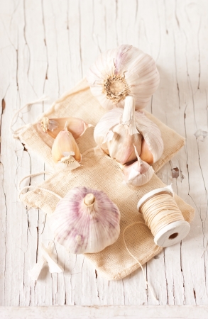 Fresh garlic on an old wooden board.の写真素材