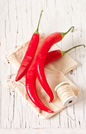 Red chili on an old wooden board.の写真素材