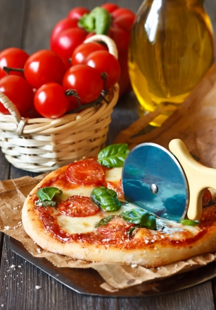 Rustic italian pizza with mozzarella, tomatoes and basil close-up.の写真素材