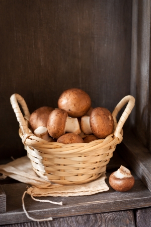 Fresh mushrooms in a small wicker basket.の写真素材