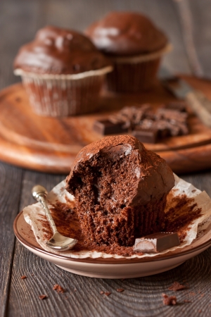 Delicious chocolate muffins with spoon and chocolate bar close-up.の写真素材