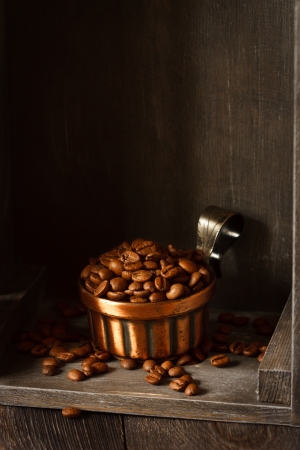 Roasted coffee beans in a metal cup.の写真素材