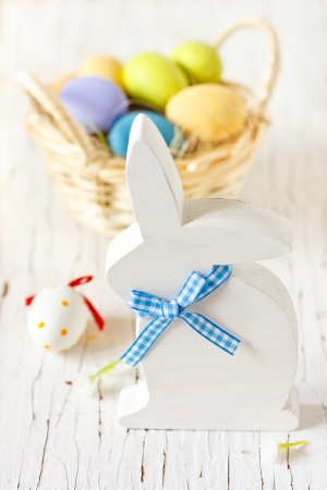 Easter decorations with white wooden bunny and colorful eggs.の写真素材