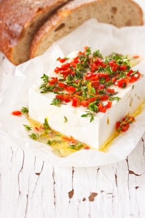 Marinated cheese with olive oil, thyme, chili and lemon zest.の写真素材