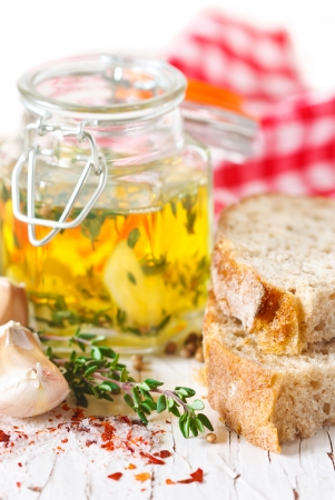 Garlic olive oil with thyme and fresh bread.の写真素材
