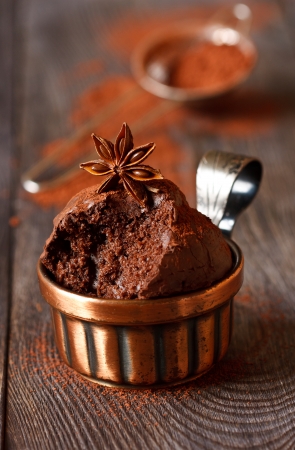 Delicious chocolate muffins with anise star and cocoa close-up.の写真素材